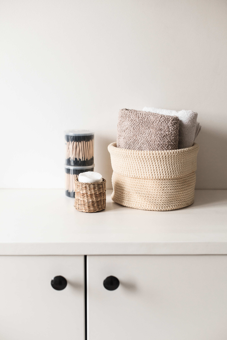 Towels, Candle, and Matches on a Cabinet Top